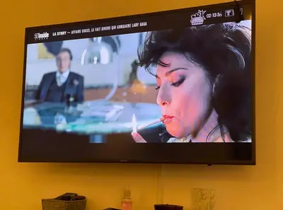 a television screen with a woman smoking a cigarette at Camilia Appart 2P TGV in Rabat