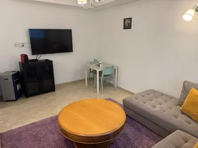 a living room with a couch and a table at Camilia Appart 2P TGV in Rabat