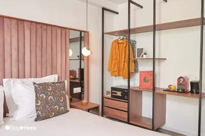 a bedroom with a bed with a large wooden headboard at Stayhere Rabat - Agdal 4 - Hotel in Rabat