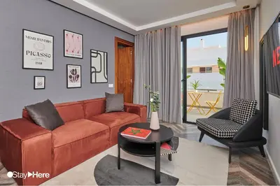 a living room with a couch and a table at Stayhere Rabat - Agdal 4 - Hotel in Rabat