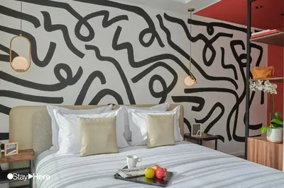 a bedroom with a bed with a black and white wall at Stayhere Rabat - Agdal 4 - Hotel in Rabat