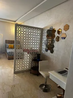 a room with a wall with a display of wine bottles at Appartement confortable et pas cher au parc in Mohammedia