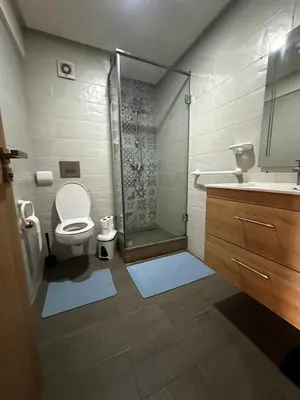 a bathroom with a shower and a toilet and a sink at Appartement confortable et pas cher au parc in Mohammedia