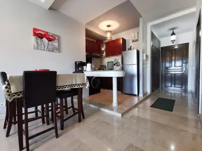 a kitchen with a table and a refrigerator at Blume Apartment Casa Port - 2 Bedrooms in Casablanca
