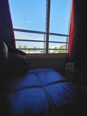 a bed in a room with a large window at Blume Apartment Casa Port - 2 Bedrooms in Casablanca