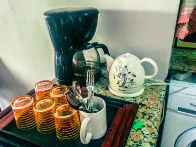 a counter with a coffee pot and cups and utensils at Blume Apartment Casa Port - 2 Bedrooms in Casablanca
