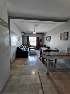 a living room with a couch and a table at Blume Apartment Casa Port - 2 Bedrooms in Casablanca