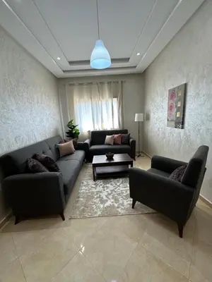 a living room with two couches and a table at Apparemment de luxe Bouznika in Bouznika