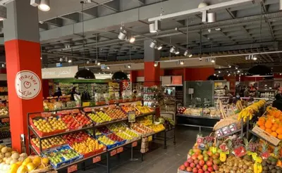 a grocery store filled with lots of fruits and vegetables at Apparemment de luxe Bouznika in Bouznika