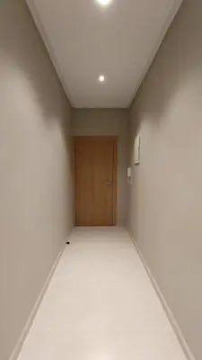 an empty room with a wooden door in it at Beautiful apartment next to airport Mohamed V in Derroua