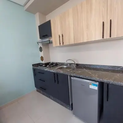 a kitchen with a sink and a counter top at appartement moderne proche aéroport in Derroua