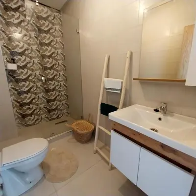 a bathroom with a toilet and a sink at appartement moderne proche aéroport in Derroua