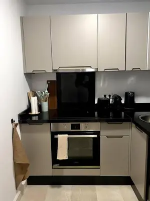a kitchen with a stove and a microwave at Jade - Appartement Luxe - Casablanca in Casablanca