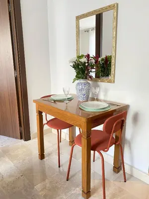 a wooden table with two chairs and a mirror at Jade - Appartement Luxe - Casablanca in Casablanca