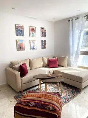 a living room with a couch and a table at Jade - Appartement Luxe - Casablanca in Casablanca