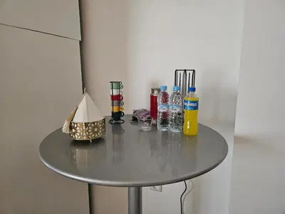 a small table with bottles and glasses on it at Cozy Apartment with Veranda Downtown in Casablanca
