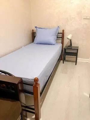 a bedroom with a bed with a blue pillow on it at L'Appartement Harmonia Cozy in Casablanca