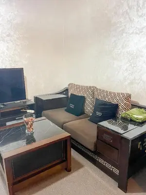 a living room with a couch and a coffee table at L'Appartement Harmonia Cozy in Casablanca