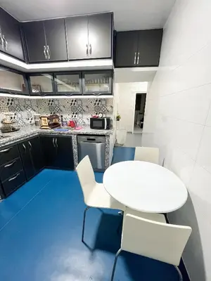 a kitchen with a white table and white chairs at L'Appartement Harmonia Cozy in Casablanca