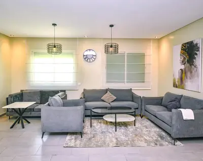 a living room with couches and a table at Cozy Central - Gym & Spa Srvcs in Casablanca