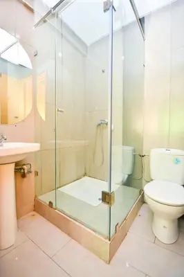 a bathroom with a shower with a toilet and a sink at Cozy Central - Gym & Spa Srvcs in Casablanca
