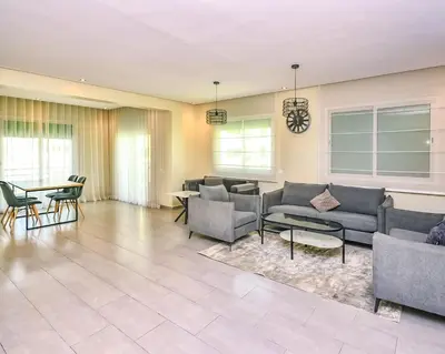 a living room with couches and chairs and a table at Cozy Central - Gym & Spa Srvcs in Casablanca
