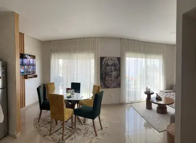 a dining room with a table and chairs at Vague Bleue chez Makuja Home in Bouznika