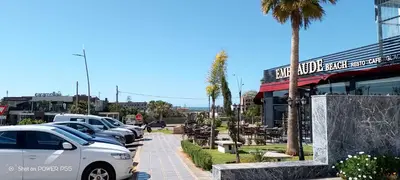 a row of cars parked in front of a restaurant at Résidence de vacances vue piscine plages Mimosas Sablettes in Mohammedia