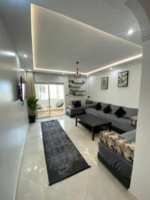 a living room with a couch and a table at Lovely 2 bedroom apartment in Rabat