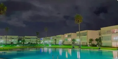 a large pool of water in front of a building at Lovely apartment at Ola Blanca 2 with WiFi in Sidi Rahal