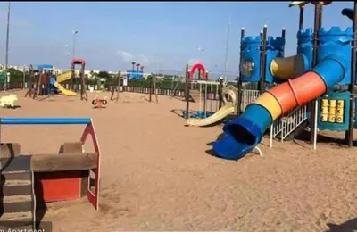 a playground with a slide in the sand at Lovely apartment at Ola Blanca 2 with WiFi in Sidi Rahal