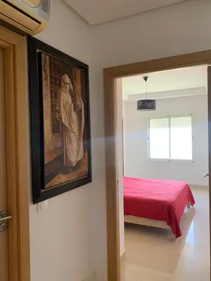 a bedroom with a bed and a painting on the wall at Lovely apartment at Ola Blanca 2 with WiFi in Sidi Rahal
