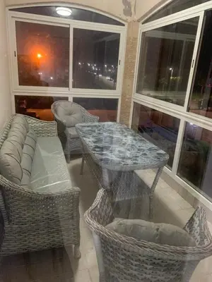 a living room with a table and chairs and windows at Lovely apartment at Ola Blanca 2 with WiFi in Sidi Rahal