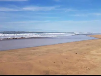 an empty beach with the ocean in the background at Lovely apartment at Ola Blanca 2 with WiFi in Sidi Rahal