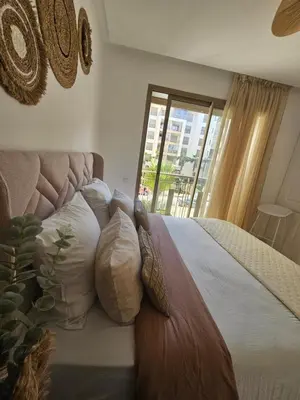 a bedroom with a bed with pillows and a window at Airport Break in Nouaceur