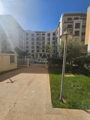 a street light in the grass in front of a building at Airport Break in Nouaceur
