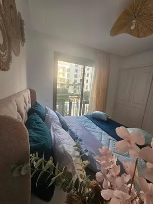 a bedroom with a bed with pillows and a window at Airport Break in Nouaceur