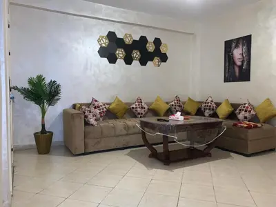 a living room with a couch and a table at Magnificent Sunlit Ground-Floor Apartment Netflix,Wi-Fi ,Comfort, Style in Casablanca