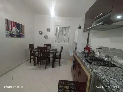 a kitchen and dining room with a table and chairs at Magnificent Sunlit Ground-Floor Apartment Netflix,Wi-Fi ,Comfort, Style in Casablanca