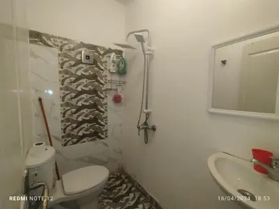 a bathroom with a toilet and a sink and a mirror at Magnificent Sunlit Ground-Floor Apartment Netflix,Wi-Fi ,Comfort, Style in Casablanca