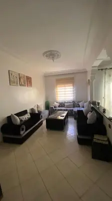 a large living room with couches and a table at Naj'Appart TEMARA WIFAK CALME SITUÉ PRÉS DE LA GARE FERROVIAIRE 4 MIN A PIED in Temara