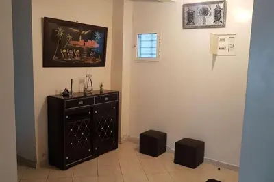 a room with a dresser and a picture on the wall at Naj'Appart TEMARA WIFAK CALME SITUÉ PRÉS DE LA GARE FERROVIAIRE 4 MIN A PIED in Temara