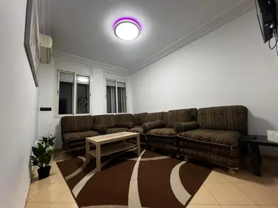 a living room with a couch and a table at Appart à 2 min de Casanearshore in Casablanca