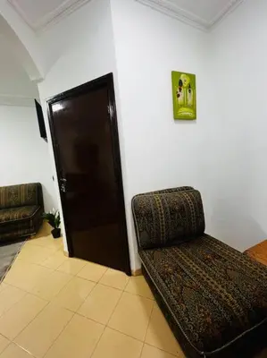 a living room with a couch and a door at Appart à 2 min de Casanearshore in Casablanca