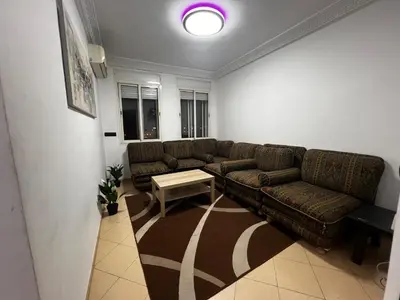 a living room with a couch and a table at Appart à 2 min de Casanearshore in Casablanca