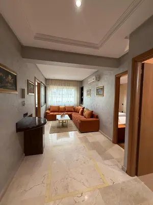 a living room with a couch and a table at Appart Hôtel Oleandro in Casablanca