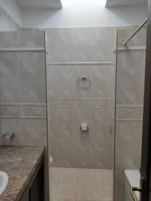 a shower with a glass door in a bathroom at Villa à la décoration marocaine in Rabat