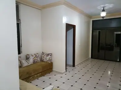 a living room with a couch and a tiled floor at Villa à la décoration marocaine in Rabat