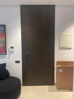 a brown door in a room with a box at Magic Appartement Luxury Gauthier 04 in Casablanca