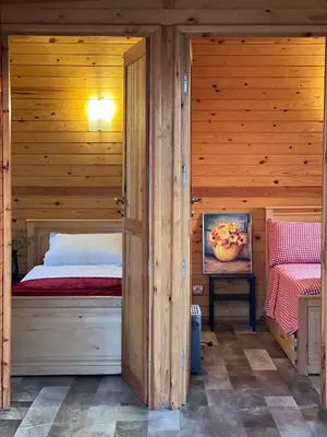 a bedroom with a bed in a wooden cabin at Ecolodge Vert, Benslimane in Oulad Youssef